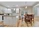 Bright kitchen with granite counters, an island, and a breakfast area with French doors at 500 Merrill Ln, Peachtree City, GA 30269