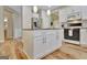 Modern kitchen featuring an island with granite countertops and white cabinets at 500 Merrill Ln, Peachtree City, GA 30269