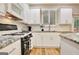 Well-lit kitchen featuring granite countertops, white cabinets, and stainless steel appliances at 500 Merrill Ln, Peachtree City, GA 30269
