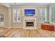 Bright living room featuring a fireplace, large windows, and hardwood floors at 500 Merrill Ln, Peachtree City, GA 30269