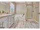Elegant main bathroom featuring a soaking tub, separate glass shower, and a vanity with marble countertops at 500 Merrill Ln, Peachtree City, GA 30269