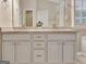Double sink vanity with granite countertops and a large mirror in the bright and functional main bathroom at 500 Merrill Ln, Peachtree City, GA 30269