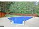 Beautiful in-ground swimming pool with fence and mature shade trees at 500 Merrill Ln, Peachtree City, GA 30269