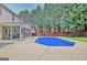 Outdoor swimming pool with a sunroom and fenced-in backyard perfect for relaxation and recreation at 500 Merrill Ln, Peachtree City, GA 30269