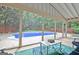 Backyard pool area with a spacious patio and lush greenery, ideal for summer fun at 500 Merrill Ln, Peachtree City, GA 30269