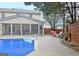 Backyard with a swimming pool, screen porch, bench swing and privacy fence at 500 Merrill Ln, Peachtree City, GA 30269