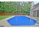 Backyard pool with patio, fence and view of the screen porch and trees at 500 Merrill Ln, Peachtree City, GA 30269