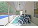 Cozy sunroom with screened windows, comfortable seating, and a view of the backyard pool at 500 Merrill Ln, Peachtree City, GA 30269
