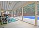 Relaxing sunroom with a ceiling fan, comfortable seating, and scenic pool views at 500 Merrill Ln, Peachtree City, GA 30269