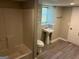 Bathroom featuring a shower, new flooring, sink, and a bright window at 3551 Skyline Sw Ter, Marietta, GA 30008