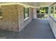Covered porch featuring brick and painted white wooden posts at 3551 Skyline Sw Ter, Marietta, GA 30008