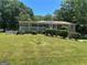 Ranch-style home with a well-manicured front lawn and a charming covered porch at 3551 Skyline Sw Ter, Marietta, GA 30008
