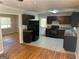Efficient kitchen with dark cabinets, black appliances, and an eat-in breakfast nook at 3551 Skyline Sw Ter, Marietta, GA 30008