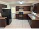 Kitchen features dark cabinets, stainless steel appliances, and tile floors at 3551 Skyline Sw Ter, Marietta, GA 30008