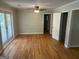 Well-lit living room with hardwood floors, fresh paint, ceiling fan and access to the covered porch at 3551 Skyline Sw Ter, Marietta, GA 30008