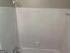 Shower with clean white tiling, overhead shower head, and neutral color palette at 3551 Skyline Sw Ter, Marietta, GA 30008