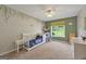 This bedroom features neutral walls and a window overlooking the backyard at 6645 N Glen Dr, Cumming, GA 30028