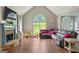 Spacious living room with large windows, fireplace, and hardwood floors at 6645 N Glen Dr, Cumming, GA 30028