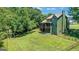 Spacious backyard featuring a well-maintained lawn, wooded area, home exterior and fenced in yard at 940 Planters Pl, Loganville, GA 30052
