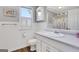 Well-lit bathroom features white wainscoting, classic fixtures, and hardwood floors at 940 Planters Pl, Loganville, GA 30052