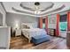 Spacious bedroom with a trey ceiling, hardwood floors, and a sitting bench at 940 Planters Pl, Loganville, GA 30052