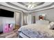 Bedroom features hard floors, trey ceilings, a mounted TV, and closet access at 940 Planters Pl, Loganville, GA 30052