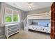 Charming bedroom features twin bunk beds, neutral paint, and view to the backyard at 940 Planters Pl, Loganville, GA 30052