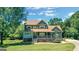 Beautiful two-story home with a covered porch and lush greenery at 940 Planters Pl, Loganville, GA 30052