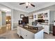 Bright home office with custom wood desk, built-in shelves, and view to the kitchen at 940 Planters Pl, Loganville, GA 30052