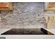 Close up of backsplash with stove at 940 Planters Pl, Loganville, GA 30052