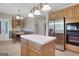 Bright kitchen with an island, stainless steel refrigerator, and wooden cabinets at 940 Planters Pl, Loganville, GA 30052