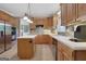 Modern kitchen featuring wood cabinets, a center island, and stainless steel appliances at 940 Planters Pl, Loganville, GA 30052