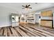 Open kitchen with stainless steel appliances and hardwood floors at 940 Planters Pl, Loganville, GA 30052