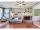 Inviting living room with a brick fireplace and hardwood floors at 940 Planters Pl, Loganville, GA 30052