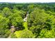 Property with ample lawn and an adjacent lush forest, offering a serene and private location at 258 Big Oak Rd, Whitesburg, GA 30185