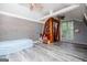Finished attic space with hardwood floors, painted walls, ceiling fan, and storage at 258 Big Oak Rd, Whitesburg, GA 30185