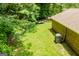 View of the backyard with a brick house, lawn and trees at 258 Big Oak Rd, Whitesburg, GA 30185
