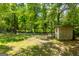 View of the backyard with a shed, lawn and trees at 258 Big Oak Rd, Whitesburg, GA 30185