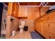Bathroom with a toilet, tub, tile flooring, wood paneled walls, a vanity and grab bars at 258 Big Oak Rd, Whitesburg, GA 30185