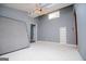Bedroom featuring modern gray walls, bright light, ceiling fan, and additional room access at 258 Big Oak Rd, Whitesburg, GA 30185