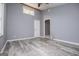 This bedroom features durable gray flooring, a ceiling fan, and natural light from the windows at 258 Big Oak Rd, Whitesburg, GA 30185