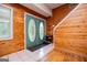 Inviting entryway boasts wood-paneled walls, decorative double doors, and a convenient shoe rack at 258 Big Oak Rd, Whitesburg, GA 30185