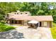 Sprawling tan and brick home with multiple entrances, large front yard and lots of parking at 258 Big Oak Rd, Whitesburg, GA 30185