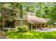 Exterior view of the brick house with a covered porch and green lawn at 258 Big Oak Rd, Whitesburg, GA 30185