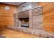 Brick fireplace with decorative logs sits against a wood-paneled wall at 258 Big Oak Rd, Whitesburg, GA 30185