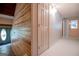 Hallway with wood paneling on one wall and access to various rooms at 258 Big Oak Rd, Whitesburg, GA 30185