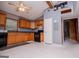 Cozy kitchen with oak cabinetry, black appliances, and vaulted ceilings at 258 Big Oak Rd, Whitesburg, GA 30185