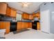 Bright kitchen features light oak cabinetry, dark countertops and black appliances at 258 Big Oak Rd, Whitesburg, GA 30185