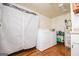 Bright laundry area with washer, dryer, white curtain and shelving for supplies at 258 Big Oak Rd, Whitesburg, GA 30185