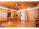 Hardwood-floored living room with built-in shelves and a sliding door hiding a refrigerator at 258 Big Oak Rd, Whitesburg, GA 30185